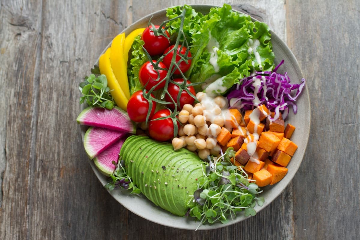 Colorful anti-inflammatory bowl with fresh vegetables, grains, and herbs