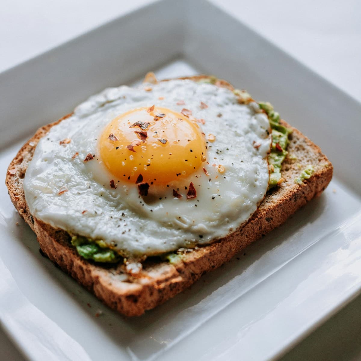 Avocado toast with seeds on artisan bread - a quick anti-inflammatory breakfast option