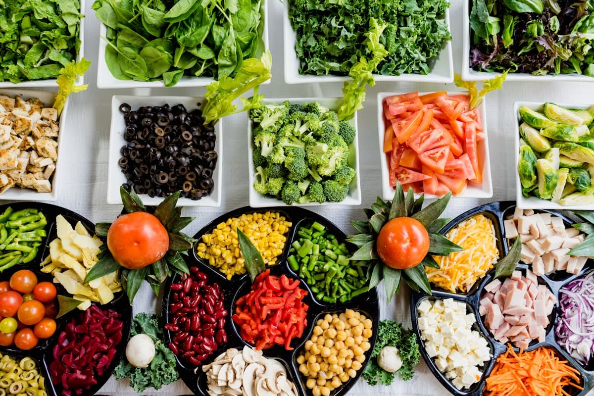 Mediterranean anti-inflammatory meal spread with vegetables, olive oil, fish, and fresh herbs